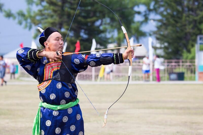 mongolian man shooting an arrow