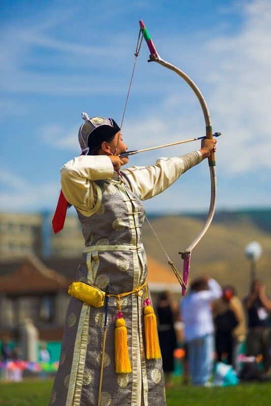 mongolian man about to shoot an arrow