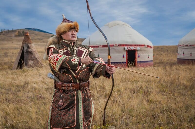 mongolian men with bow in ancient clothes