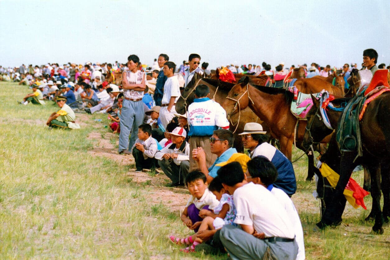 people sitting with their horses